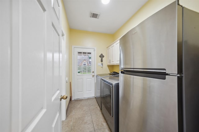 12538 W Pavilion Ct W, Tomball, TX 77377 - laundry area with separate washer and dryer, cabinet space, and light tile patterned floors