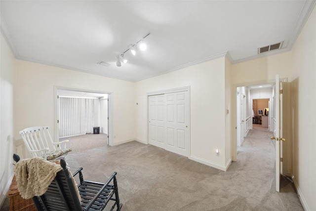 12538 W Pavilion Ct W, Tomball, TX 77377 - sitting room featuring light colored carpet, track lighting, baseboards, and crown molding