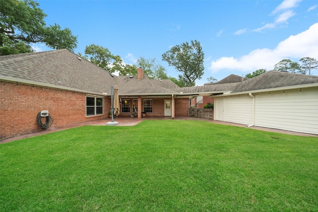 12538 W Pavilion Ct W, Tomball, TX 77377 - rear view of house featuring a chimney, a patio, brick siding, and roof with shingles