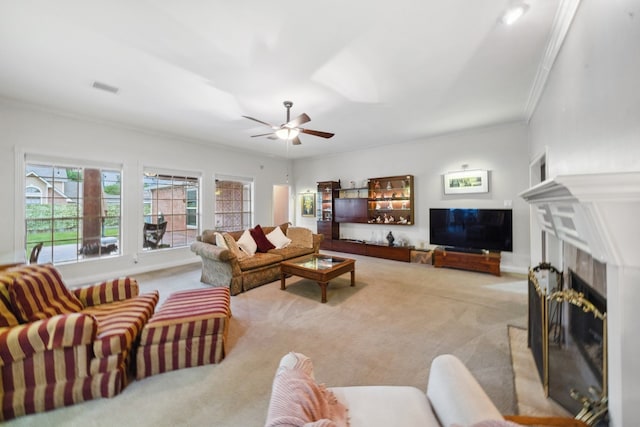 12538 W Pavilion Ct W, Tomball, TX 77377 - carpeted living room with a fireplace, crown molding, a ceiling fan, and baseboards