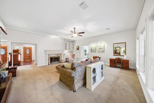 12538 W Pavilion Ct W, Tomball, TX 77377 - living room featuring crown molding, light colored carpet, ceiling fan, a high end fireplace, and baseboards