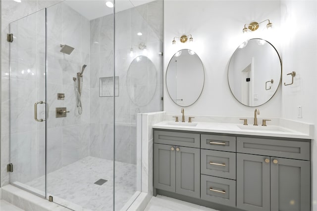 full bath featuring a sink, a shower stall, and double vanity