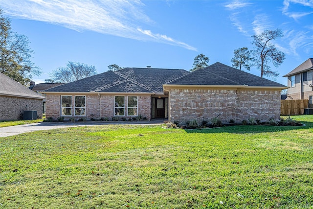 8006 17th Green Dr, Humble, TX 77346 - ranch-style house featuring a front yard, brick siding, central air condition unit, and fence