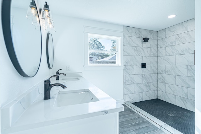 8006 17th Green Dr, Humble, TX 77346 - bathroom featuring recessed lighting, double vanity, a tile shower, and a sink