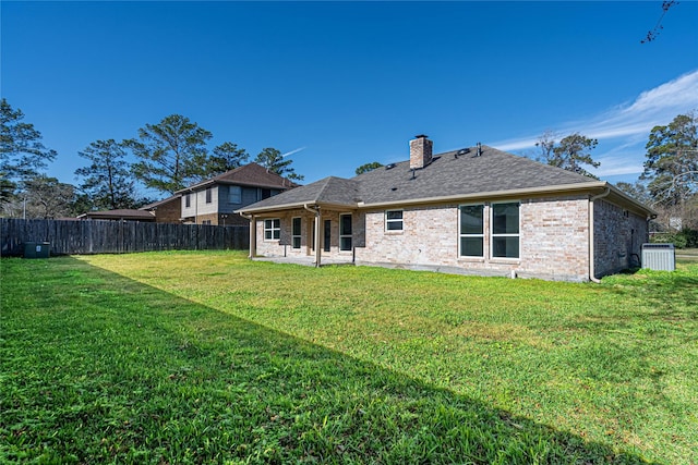 8006 17th Green Dr, Humble, TX 77346 - rear view of house featuring a yard, a fenced backyard, a patio area, brick siding, and a shingled roof