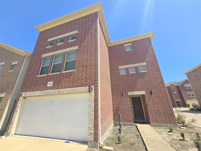view of front of property featuring a garage, driveway, and brick siding