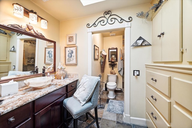 53 Litchfield Ln, Houston, TX 77024 - full bathroom featuring vanity, toilet, baseboards, stone finish flooring, and a shower