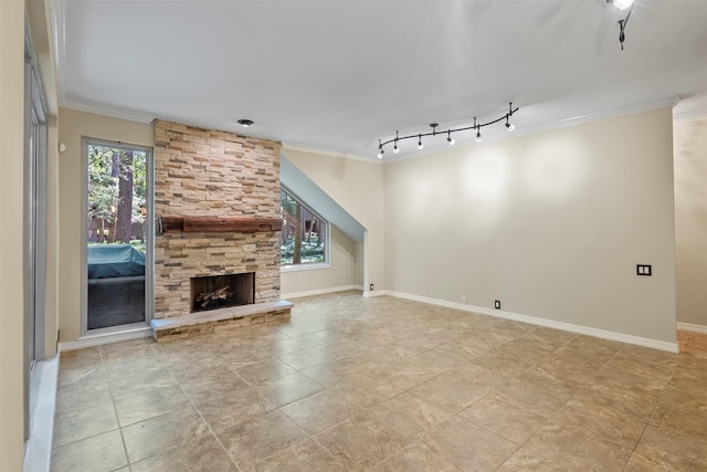 53 Litchfield Ln, Houston, TX 77024 - unfurnished living room with ornamental molding, track lighting, baseboards, and a stone fireplace