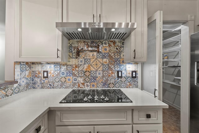 53 Litchfield Ln, Houston, TX 77024 - kitchen featuring extractor fan, black electric cooktop, light countertops, and backsplash