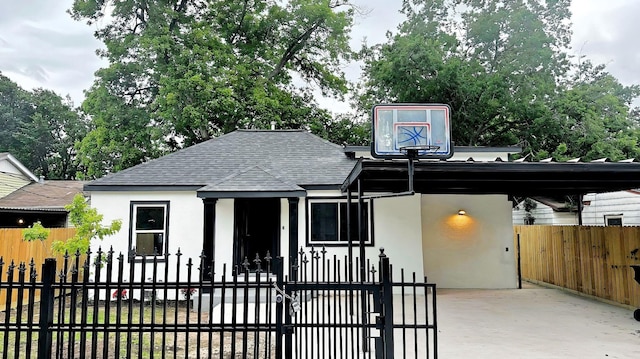 6416 Eagle Pass St, Houston, TX 77020 - exterior space featuring a fenced front yard, stucco siding, and roof with shingles