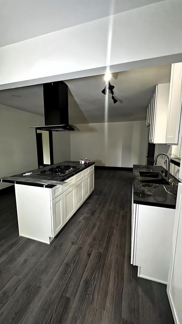6416 Eagle Pass St, Houston, TX 77020 - kitchen featuring dark wood-style flooring, dark countertops, a sink, white cabinets, and ventilation hood
