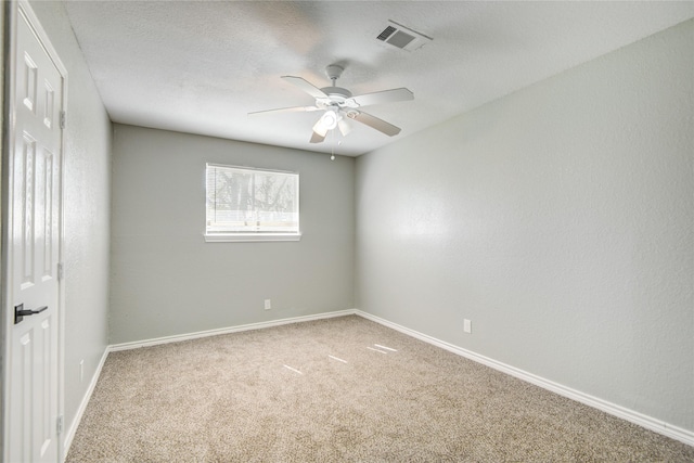 unfurnished room with baseboards, a ceiling fan, visible vents, and carpet floors