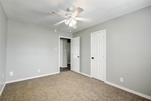 unfurnished bedroom with carpet, baseboards, and ceiling fan