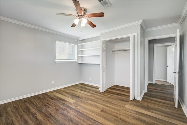 unfurnished bedroom featuring crown molding, dark wood-style flooring, baseboards, and visible vents