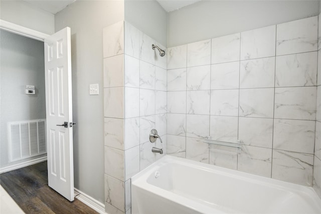 bathroom with visible vents, tub / shower combination, and wood finished floors