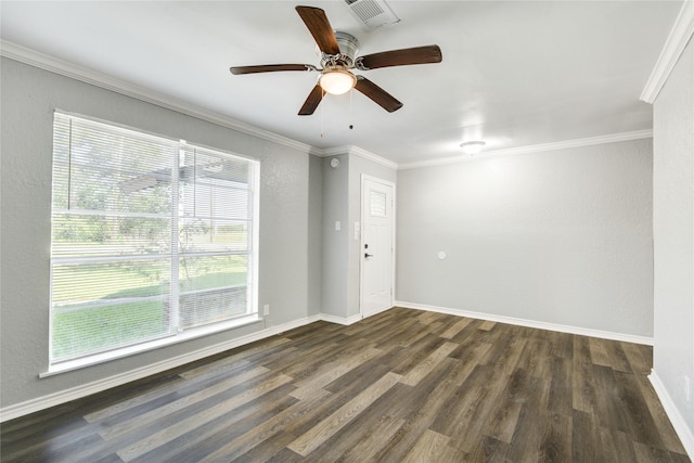 spare room with visible vents, baseboards, a ceiling fan, dark wood-style floors, and crown molding