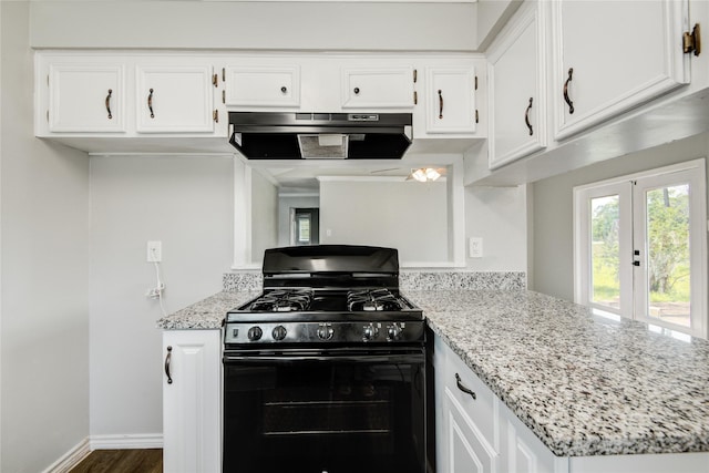 kitchen featuring dark wood-type flooring, white cabinetry, light stone counters, gas stove, and extractor fan