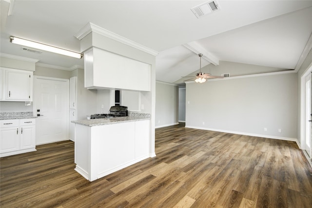 kitchen with dark wood-type flooring, gas stove, white cabinetry, and visible vents