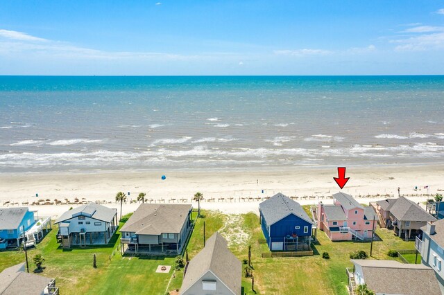 birds eye view of property with a water view, a beach view, and a residential view