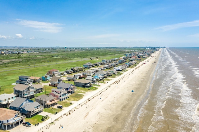bird's eye view with a water view and a beach view