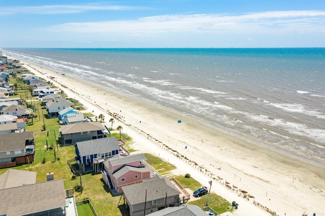 aerial view with a water view and a beach view