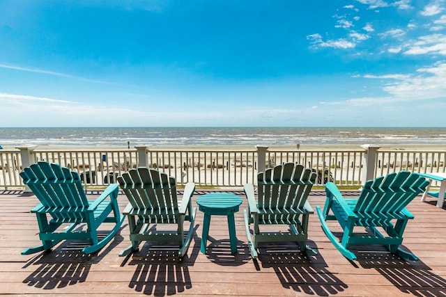 deck featuring a water view and a beach view
