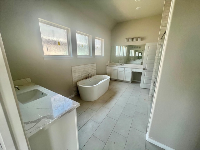 164 Peninsula Point Dr, Montgomery, TX 77356 - bathroom with double vanity, a soaking tub, and vaulted ceiling