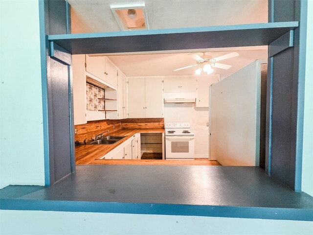 106 Jordan Ave, Cleveland, TX 77327 - kitchen with a sink, white electric stove, a ceiling fan, under cabinet range hood, and white cabinetry