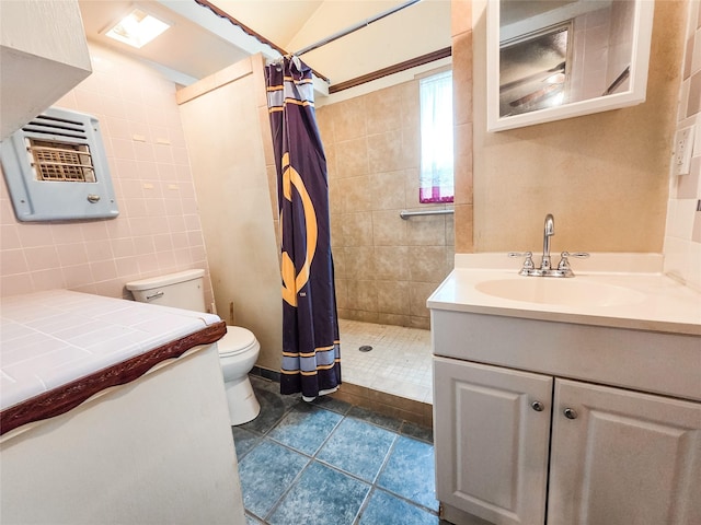 106 Jordan Ave, Cleveland, TX 77327 - full bath with tile walls, toilet, heating unit, vanity, and tiled shower