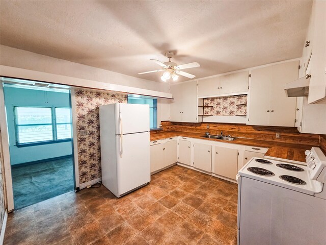 106 Jordan Ave, Cleveland, TX 77327 - kitchen with a sink, ceiling fan, white appliances, under cabinet range hood, and white cabinetry