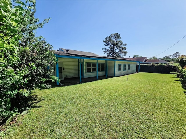 106 Jordan Ave, Cleveland, TX 77327 - rear view of house featuring fence and a lawn