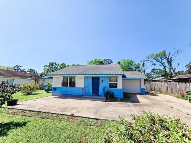 106 Jordan Ave, Cleveland, TX 77327 - view of front of house with driveway, a garage, fence, and a front yard