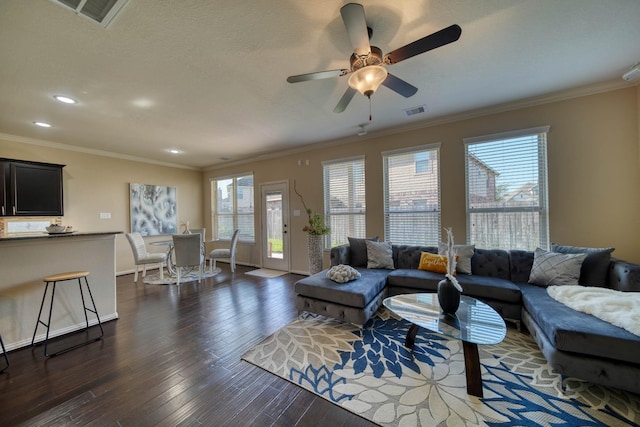 6303 Wood Creek Ln, League City, TX 77573 - living room with dark wood-style flooring, visible vents, and ornamental molding