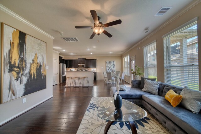 6303 Wood Creek Ln, League City, TX 77573 - living room with crown molding, dark wood-style flooring, and visible vents