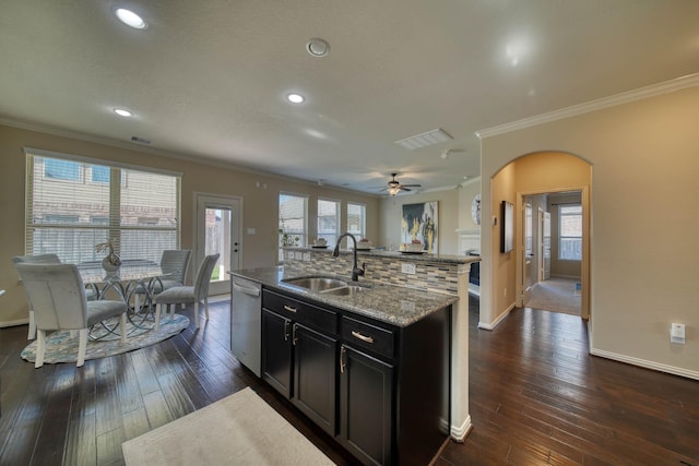 6303 Wood Creek Ln, League City, TX 77573 - kitchen with baseboards, ornamental molding, a kitchen island with sink, dishwasher, and a sink