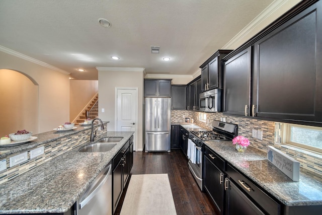 6303 Wood Creek Ln, League City, TX 77573 - kitchen with dark wood-type flooring, visible vents, dark stone countertops, a sink, and stainless steel appliances