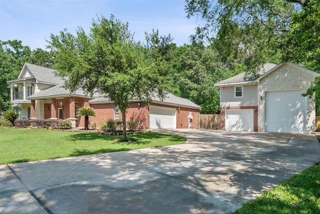 14832 Oak Shores Dr, Willis, TX 77318 - view of front of house with brick siding, a front yard, driveway, a detached garage, and roof with shingles