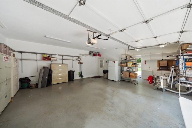 14832 Oak Shores Dr, Willis, TX 77318 - garage featuring freestanding refrigerator and a garage door opener