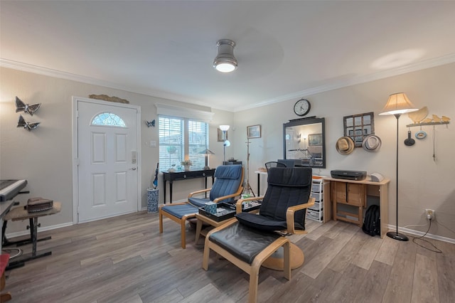 interior space featuring crown molding, wood finished floors, baseboards, and a ceiling fan