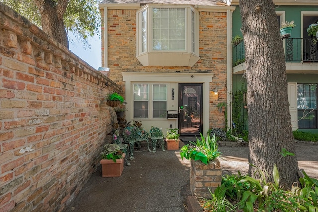 view of exterior entry with brick siding