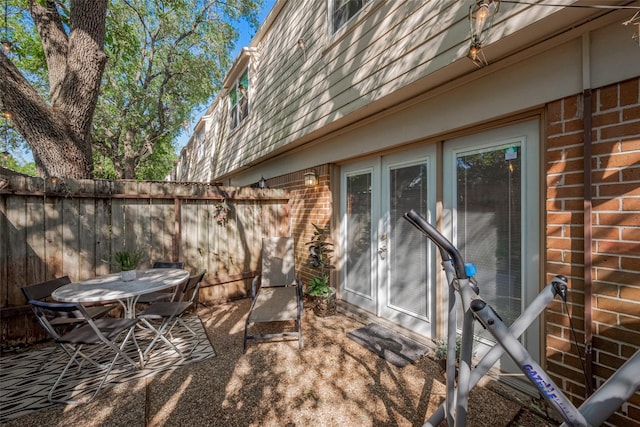 view of patio / terrace with french doors, fence, and outdoor dining area