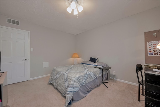 carpeted bedroom featuring visible vents and baseboards