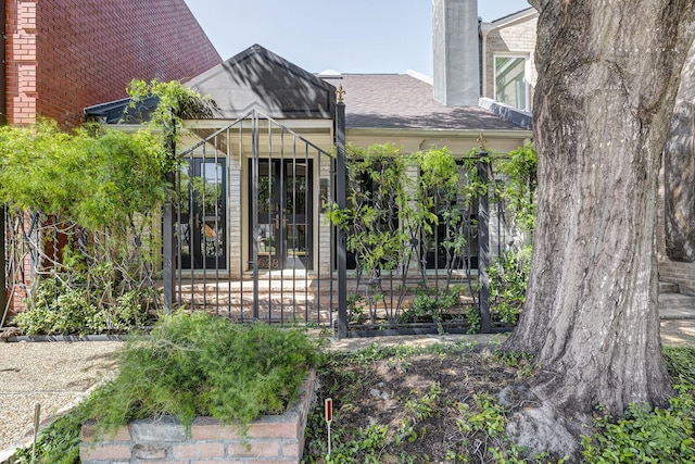 7628 Del Monte Dr, Houston, TX 77063 - property entrance featuring roof with shingles and a chimney