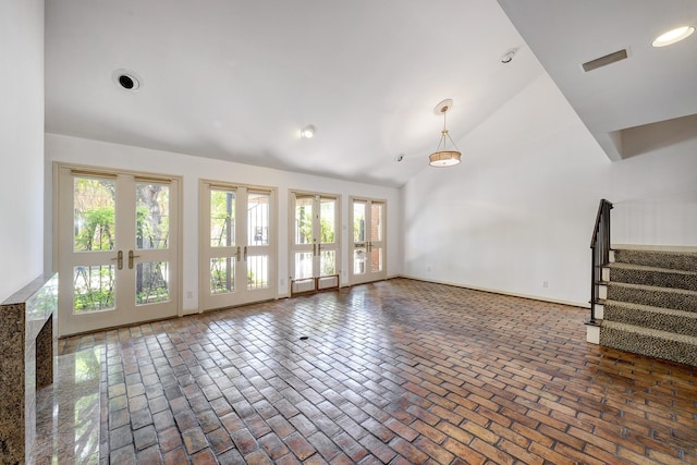 7628 Del Monte Dr, Houston, TX 77063 - unfurnished living room featuring high vaulted ceiling, stairway, brick floor, and a healthy amount of sunlight