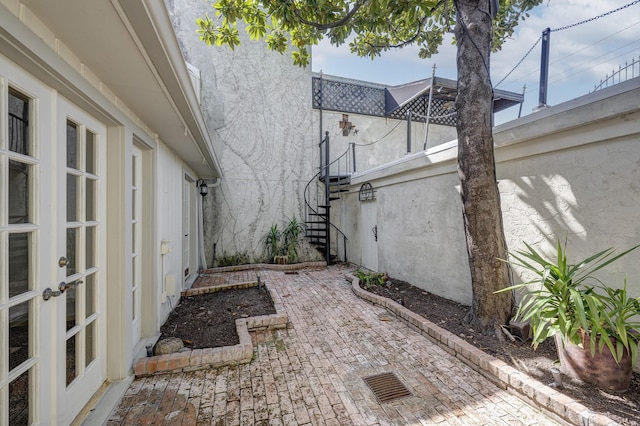 7628 Del Monte Dr, Houston, TX 77063 - view of side of home with stairs, a patio, and stucco siding