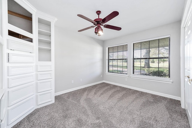 empty room with carpet flooring, baseboards, and a ceiling fan
