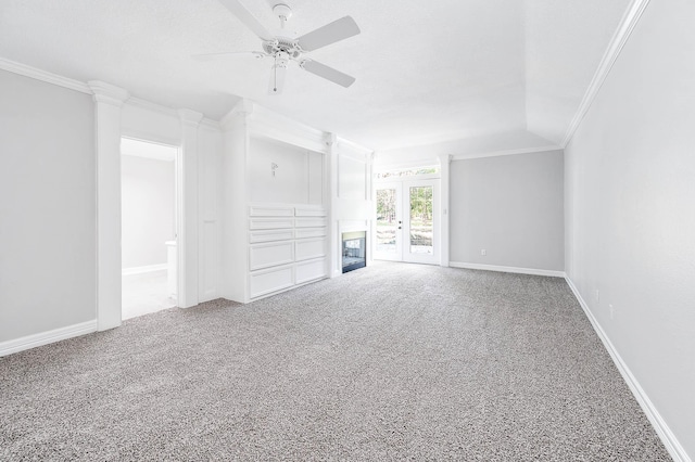unfurnished living room with carpet, baseboards, ornamental molding, and a ceiling fan