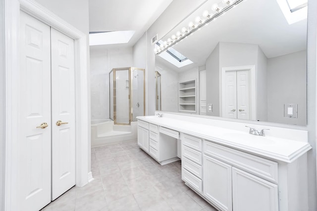bathroom with a closet, combined bath / shower with glass door, a sink, double vanity, and tile patterned floors