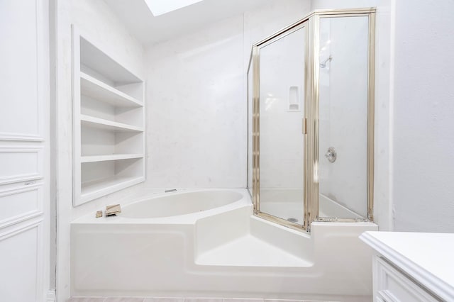 full bath with a shower with door, vanity, a garden tub, and a skylight