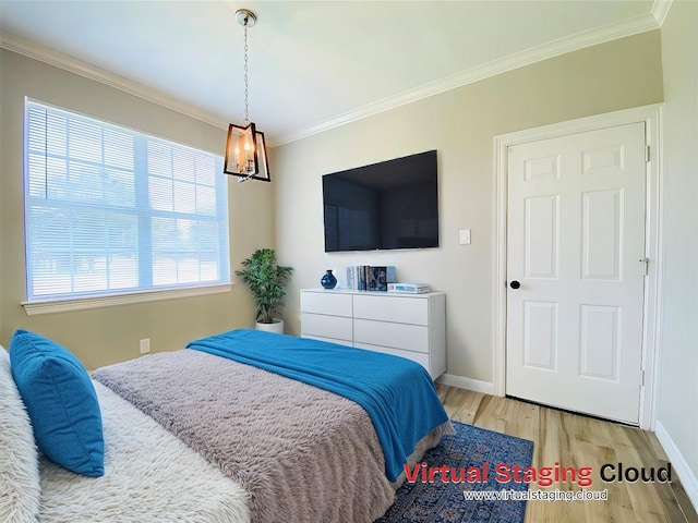bedroom with crown molding, baseboards, and wood finished floors